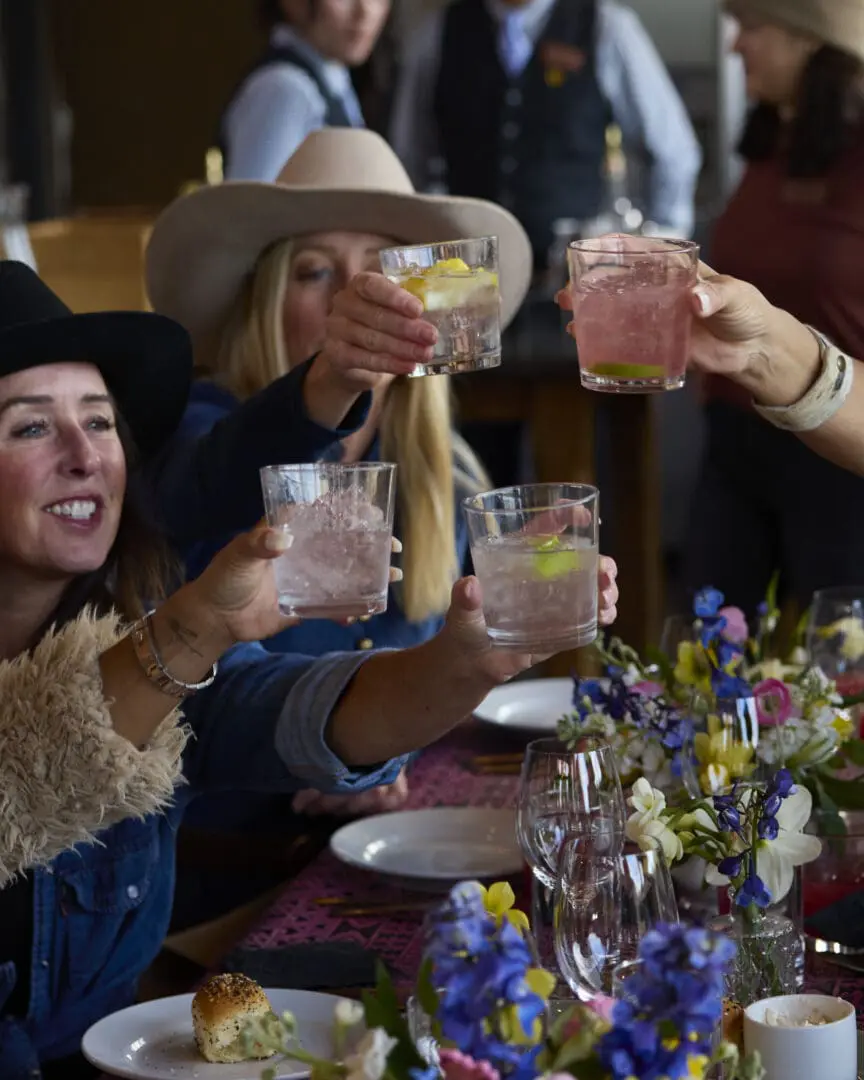 Women toasting their glasses together.
