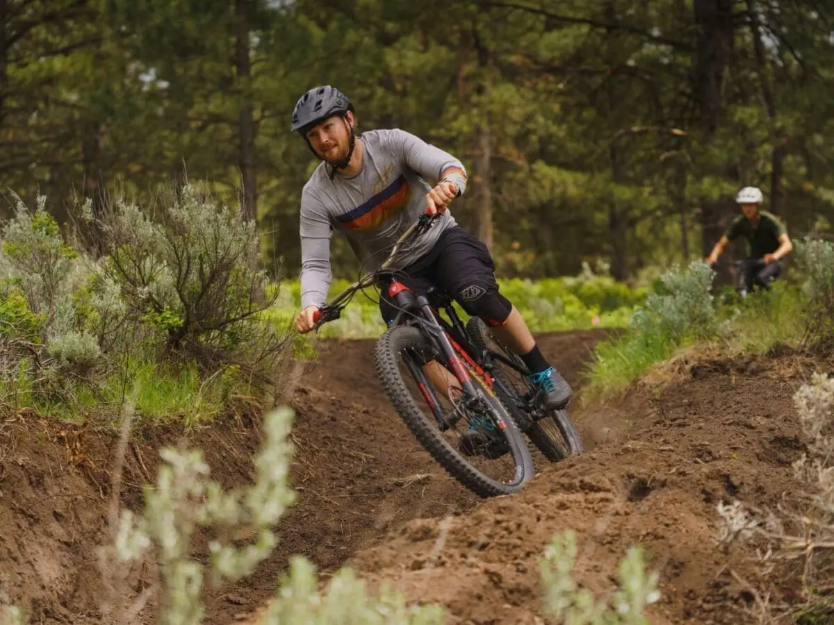 Man riding a mountain bike on a sharp dirt path turn