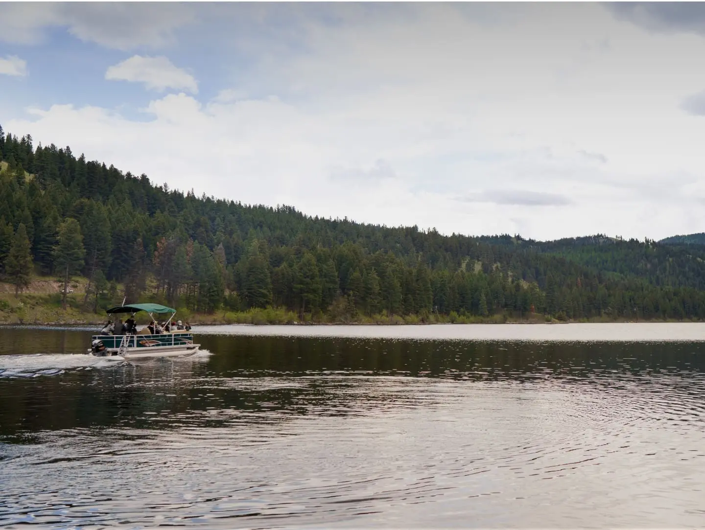 Pontoon boat cruising on a mountain lake