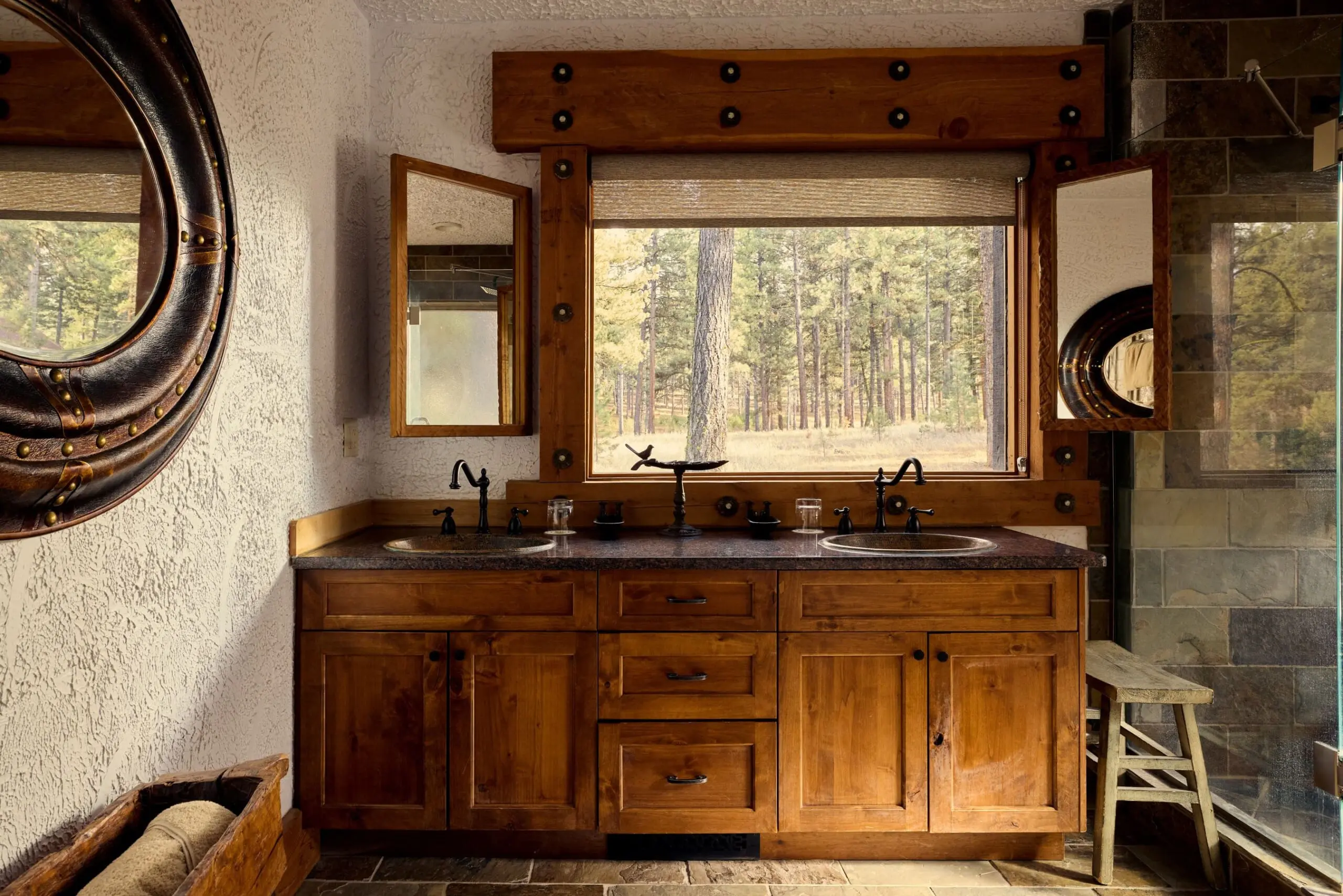Western style bathroom with forest view out the window