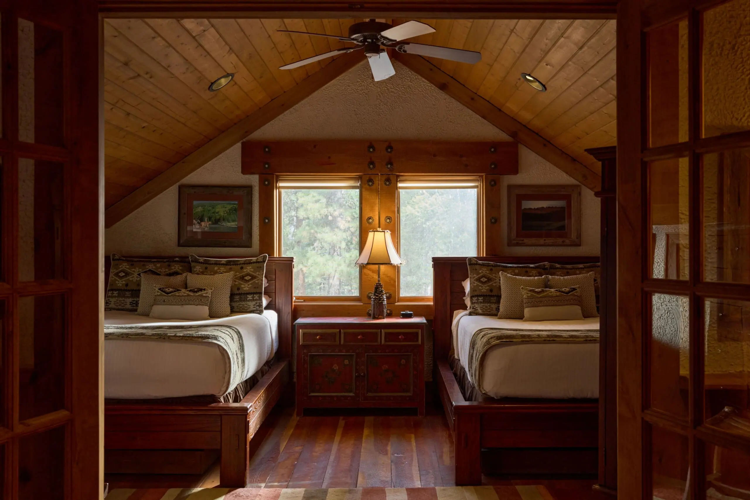 Two full beds in a western style cabin