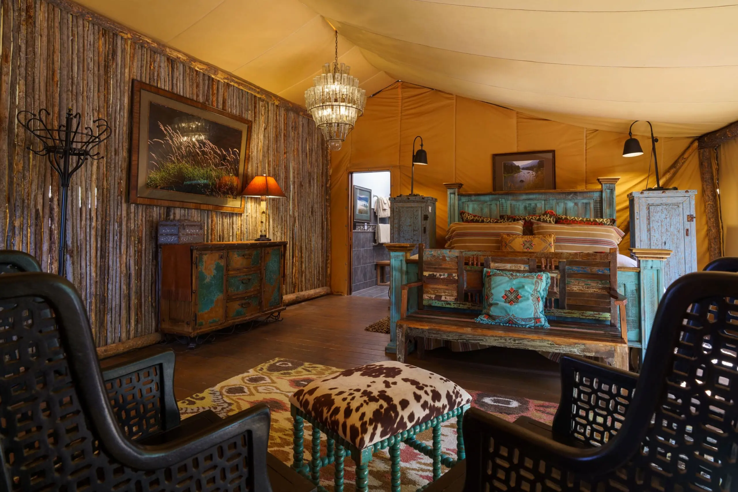 Interior of luxury canvas glamping tent with king size bed