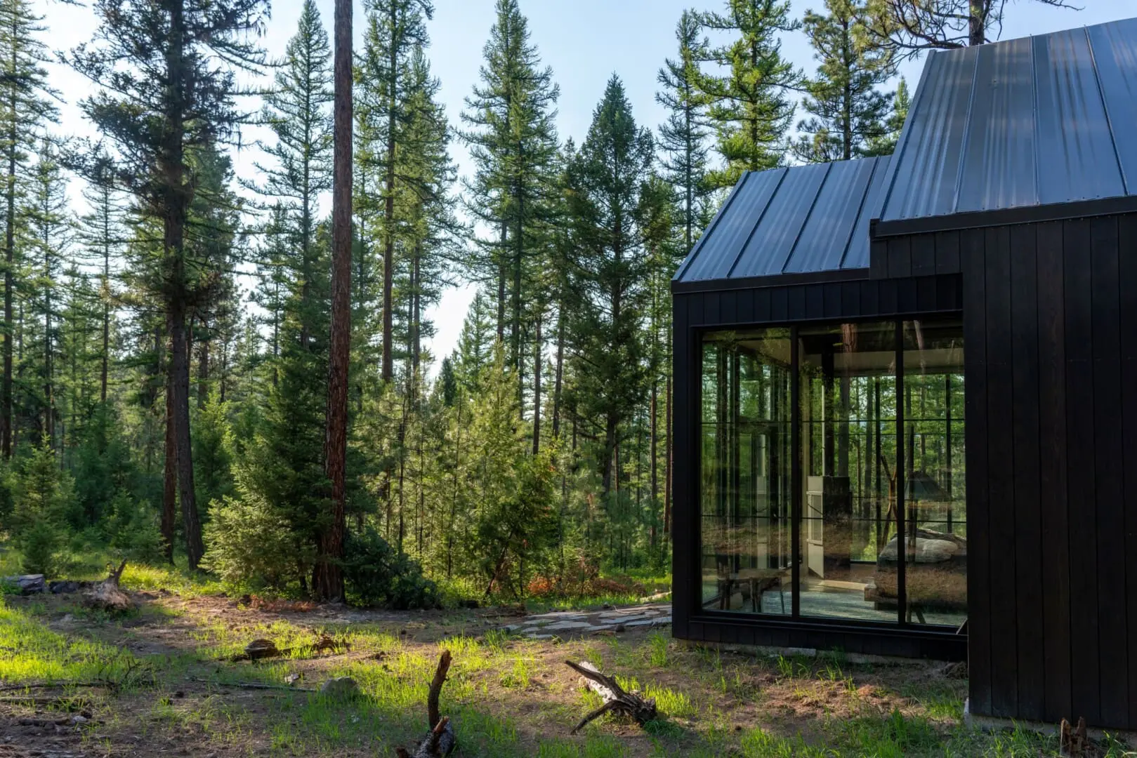 Outside of glass modern cabin in the woods