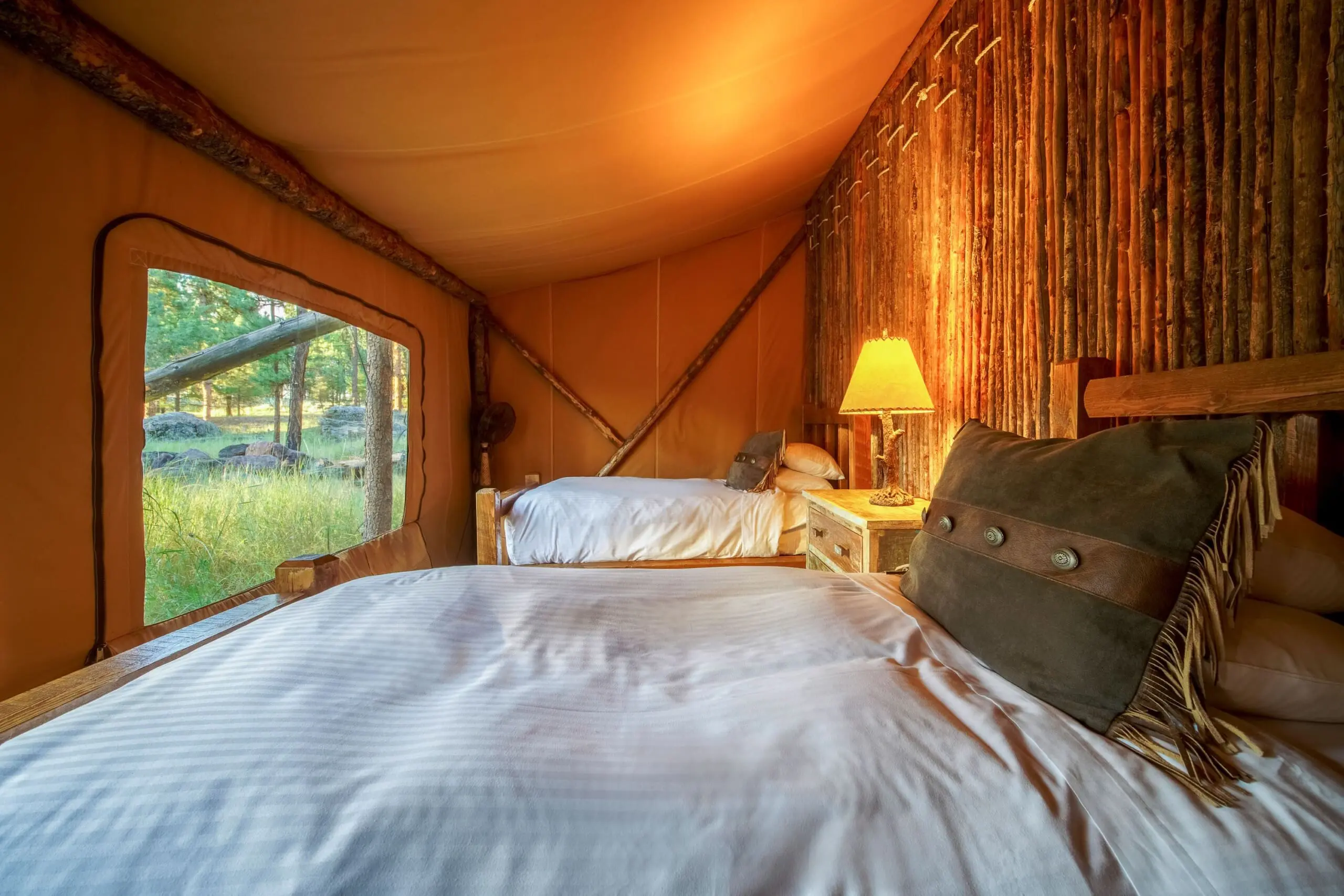 Two twin beds in a canvas glamping tent