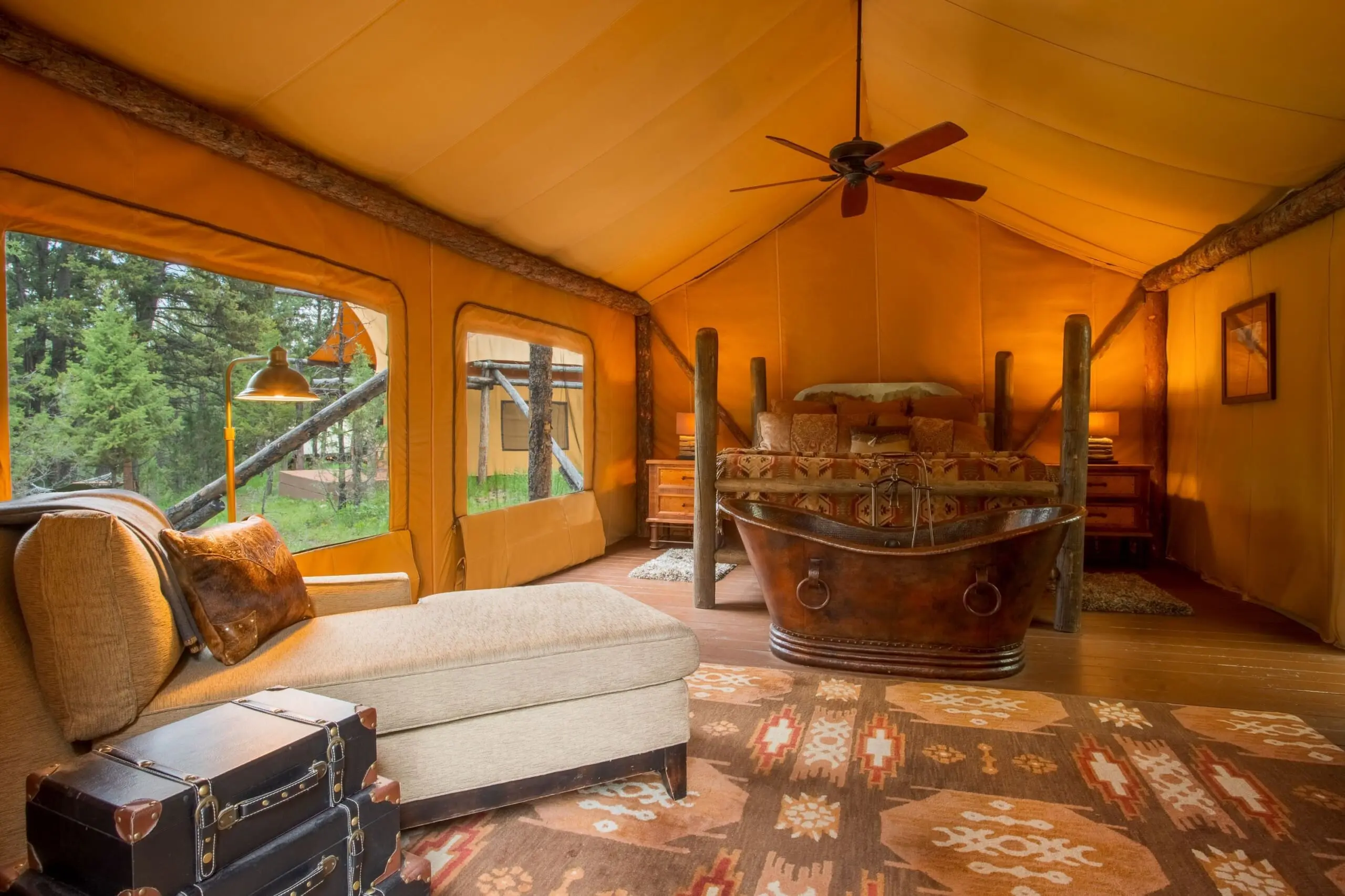 Interior of bedroom in glamping tent with king size bed
