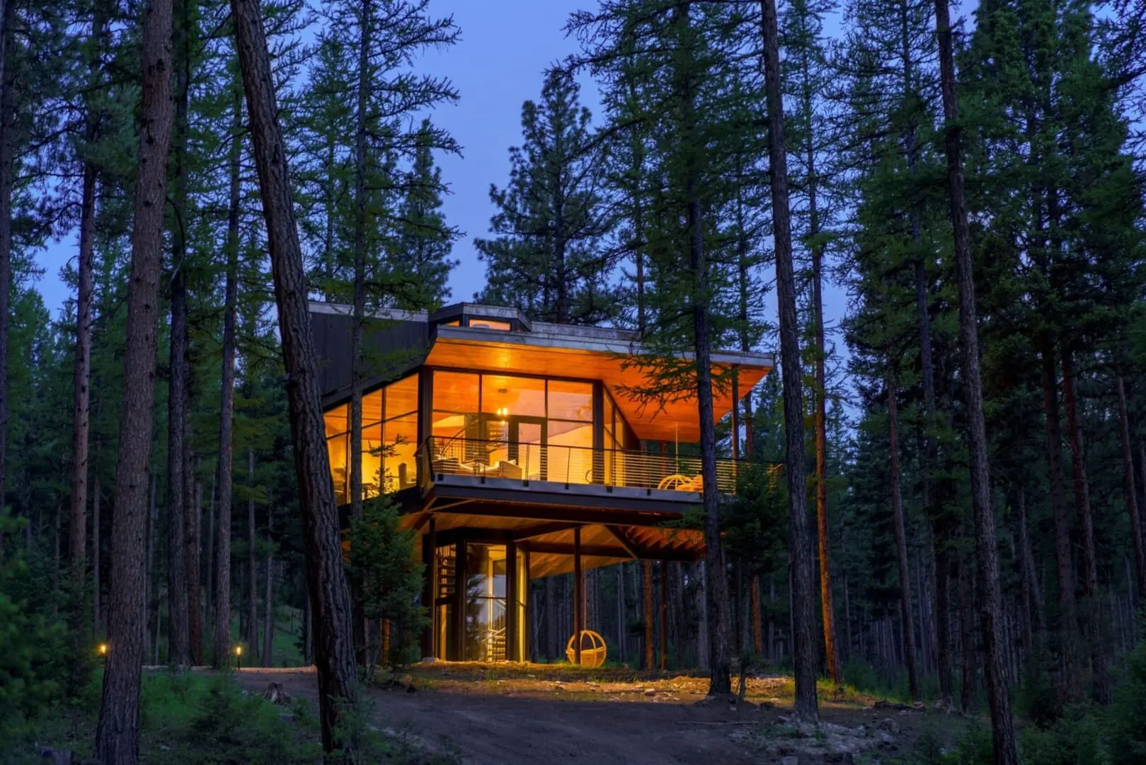 Evening exterior of modern treehouse cabin