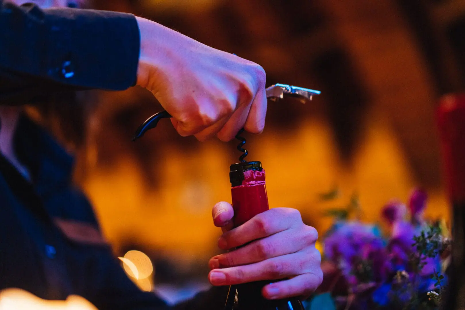 Shot of a hand uncorking wine.