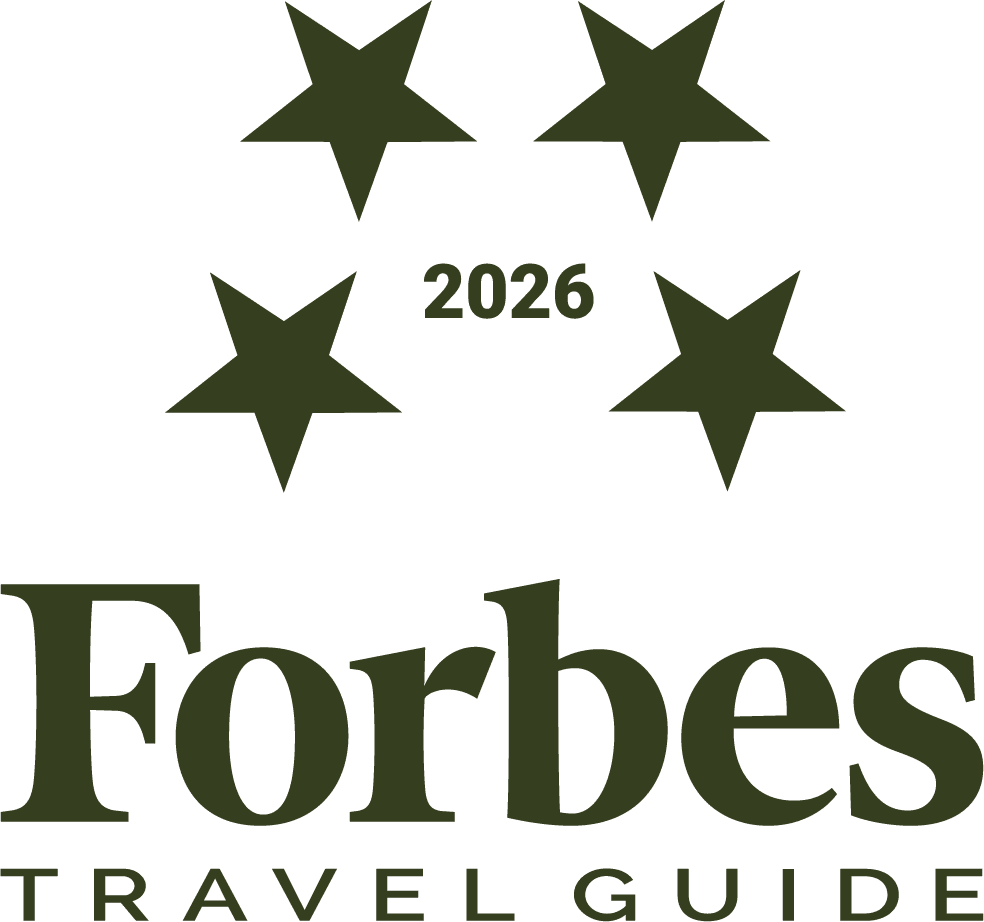 Forbes 2026 travel standards logo in color legacy pine.