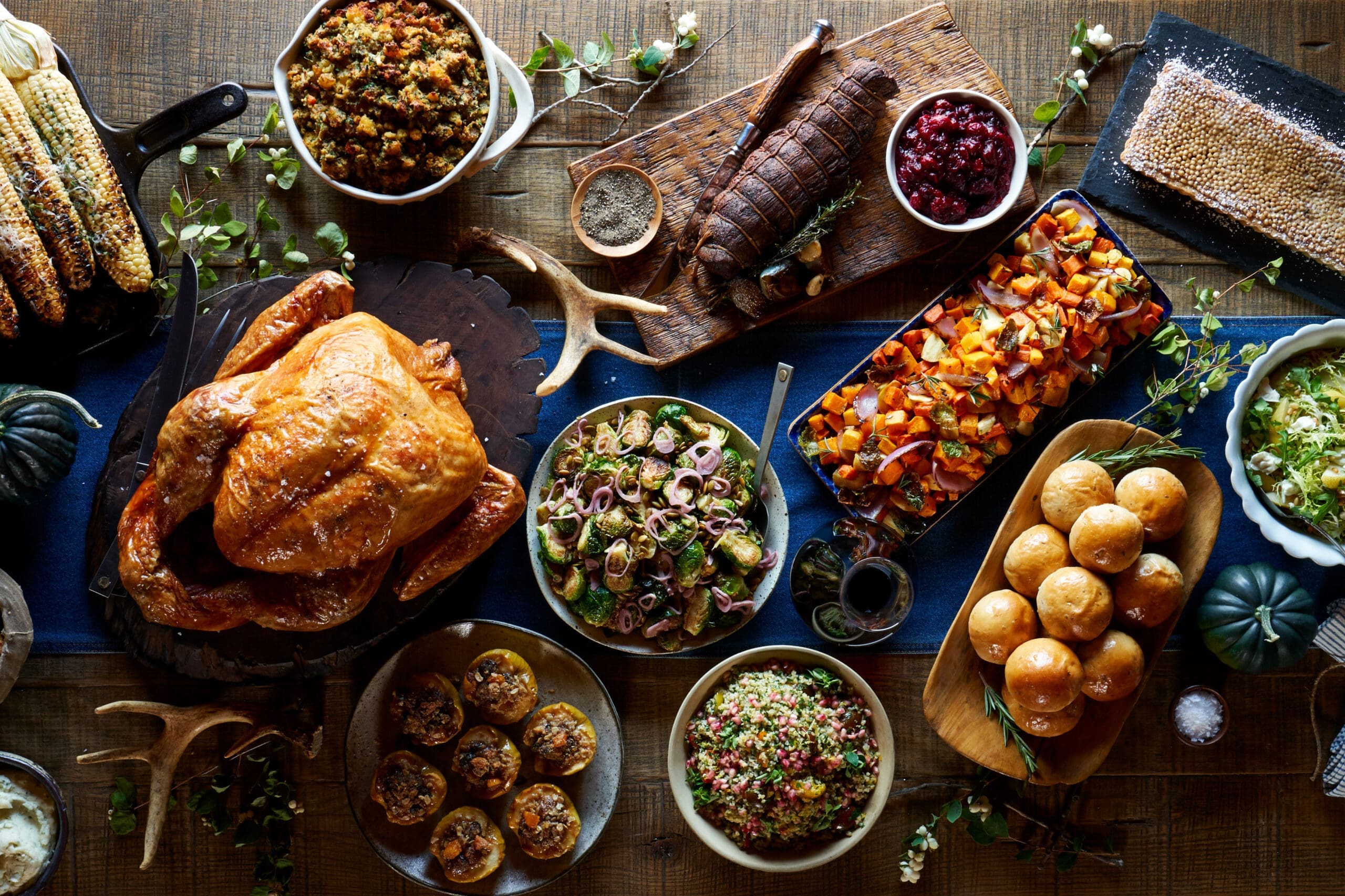 Thanksgiving array of foods with a turkey and sides.