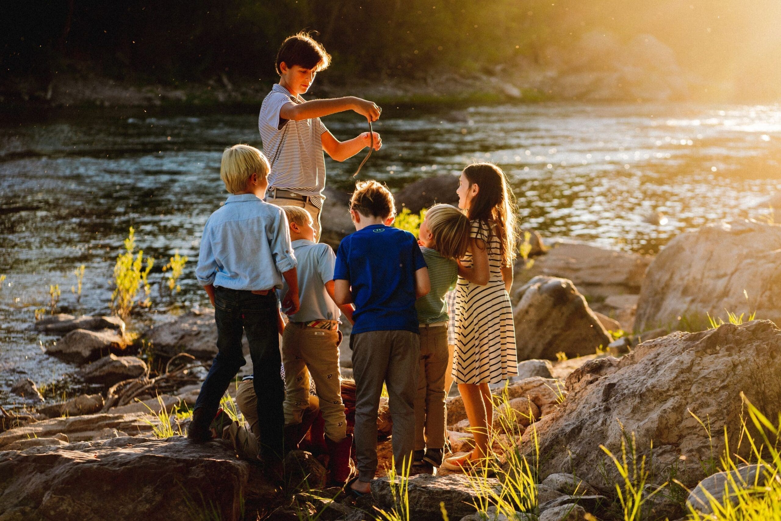 Group of kids playing on a riverbank