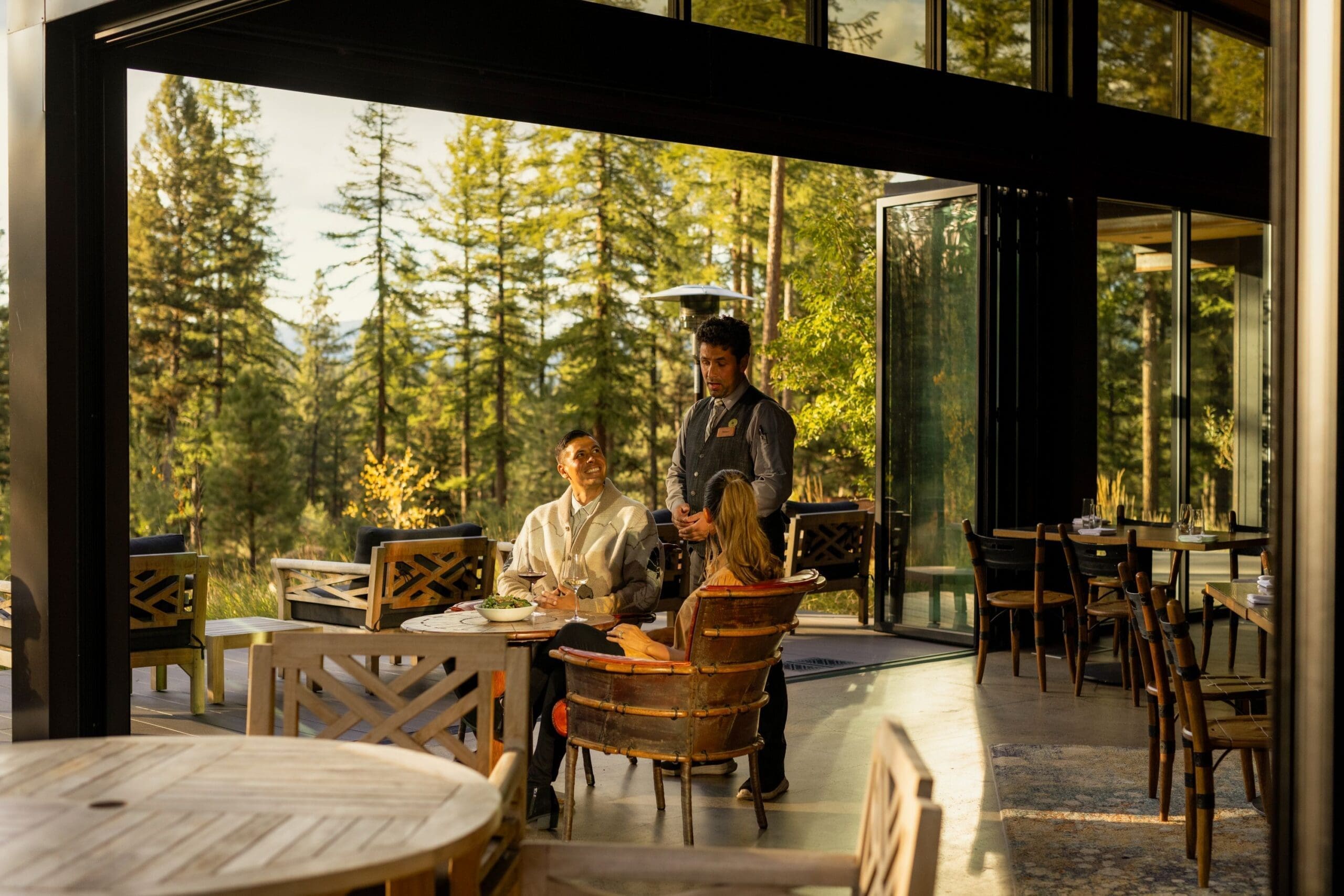 Two people being served by a waiter in a luxury resort restaurant