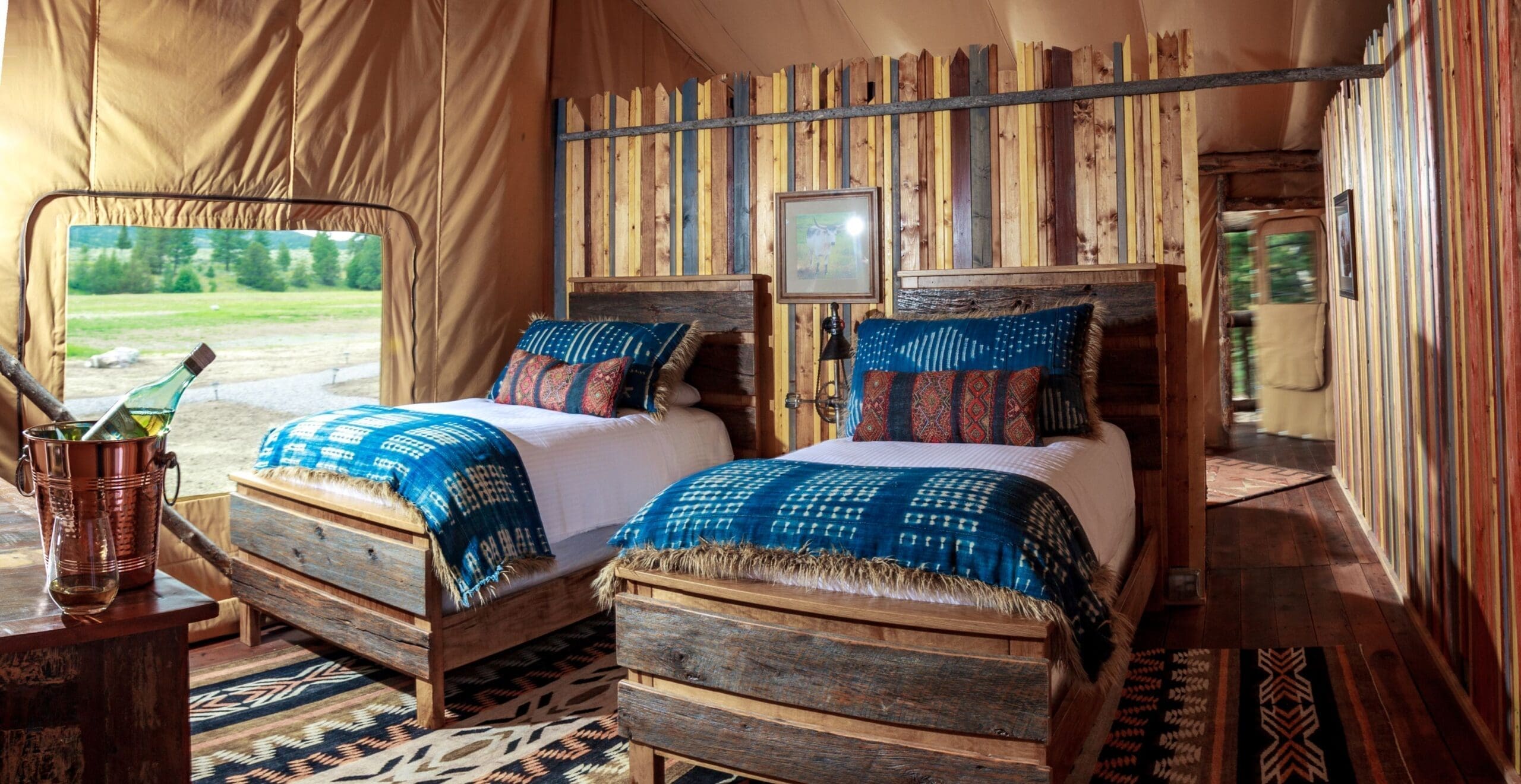 Two twin beds with western decor in a glamping tent
