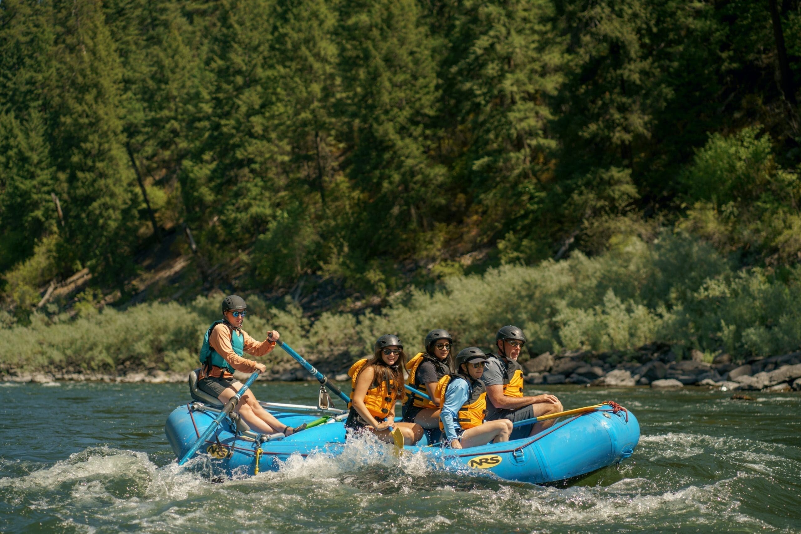 People whitewater rafting in a river