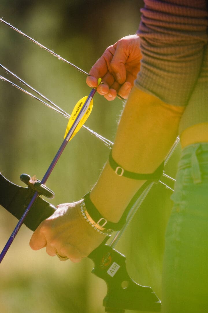 Arm notching a bow and arrow.