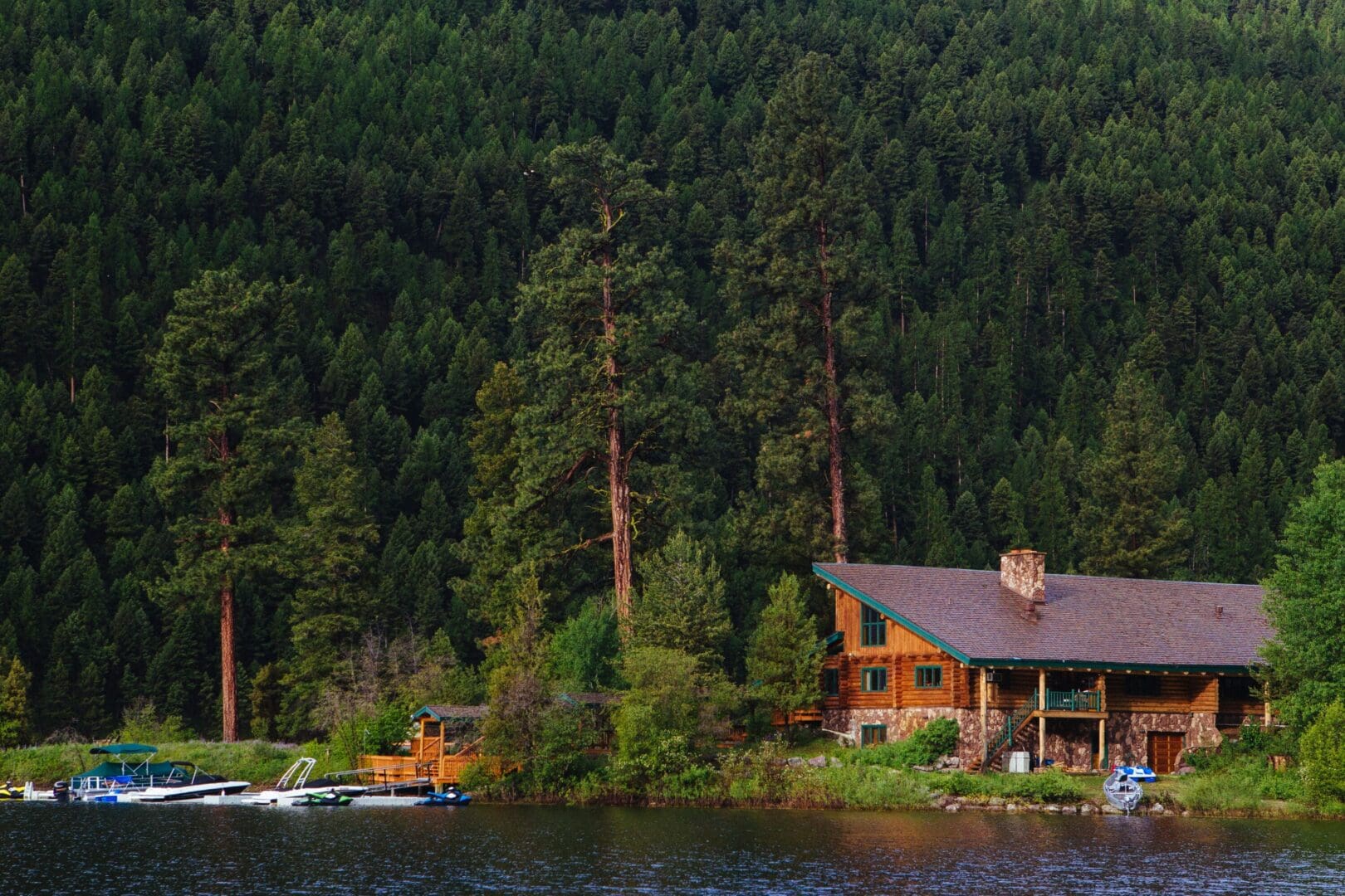 Shot of an island in the middle of a lake with a boat in the background.