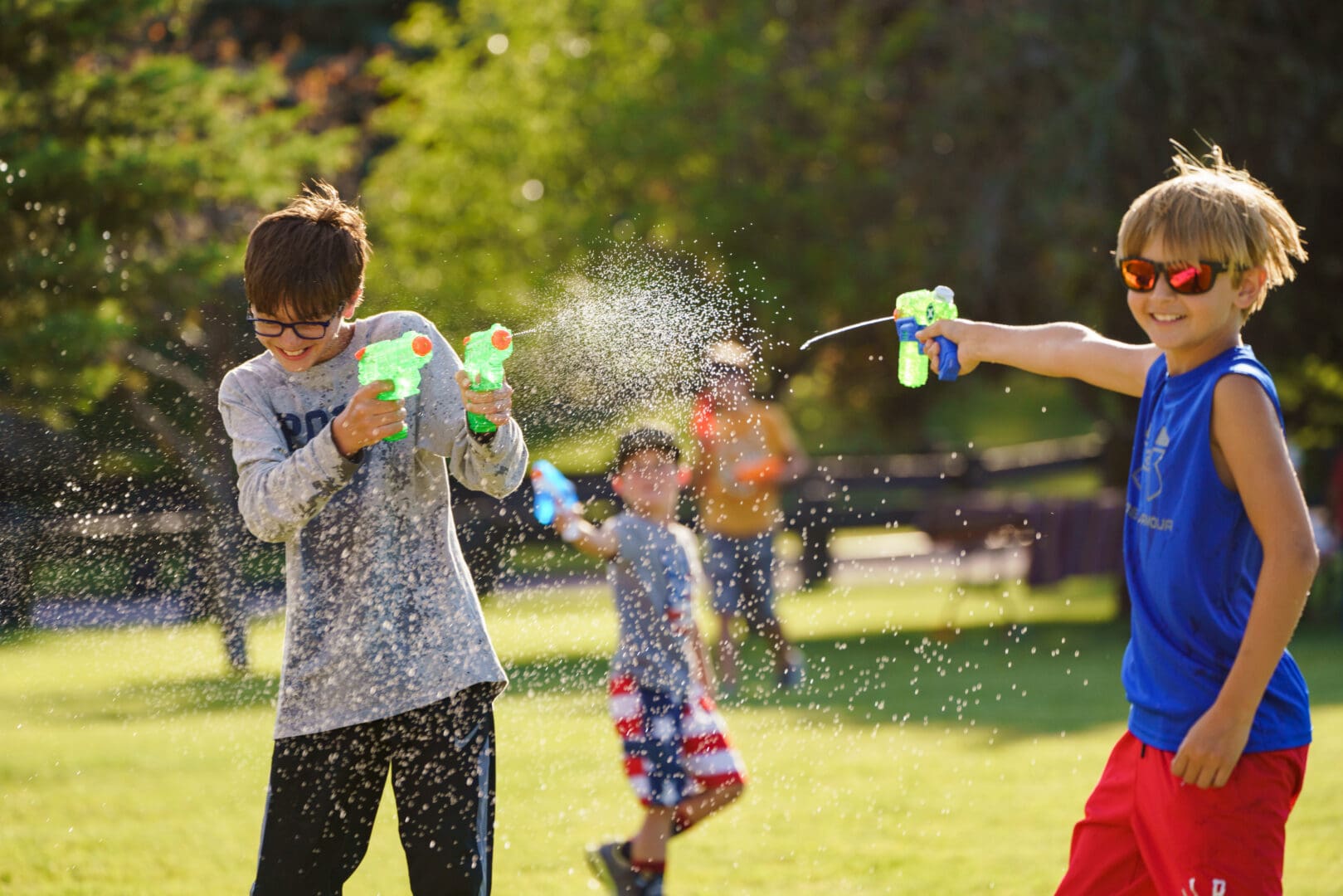 Two boys playing with water guns.