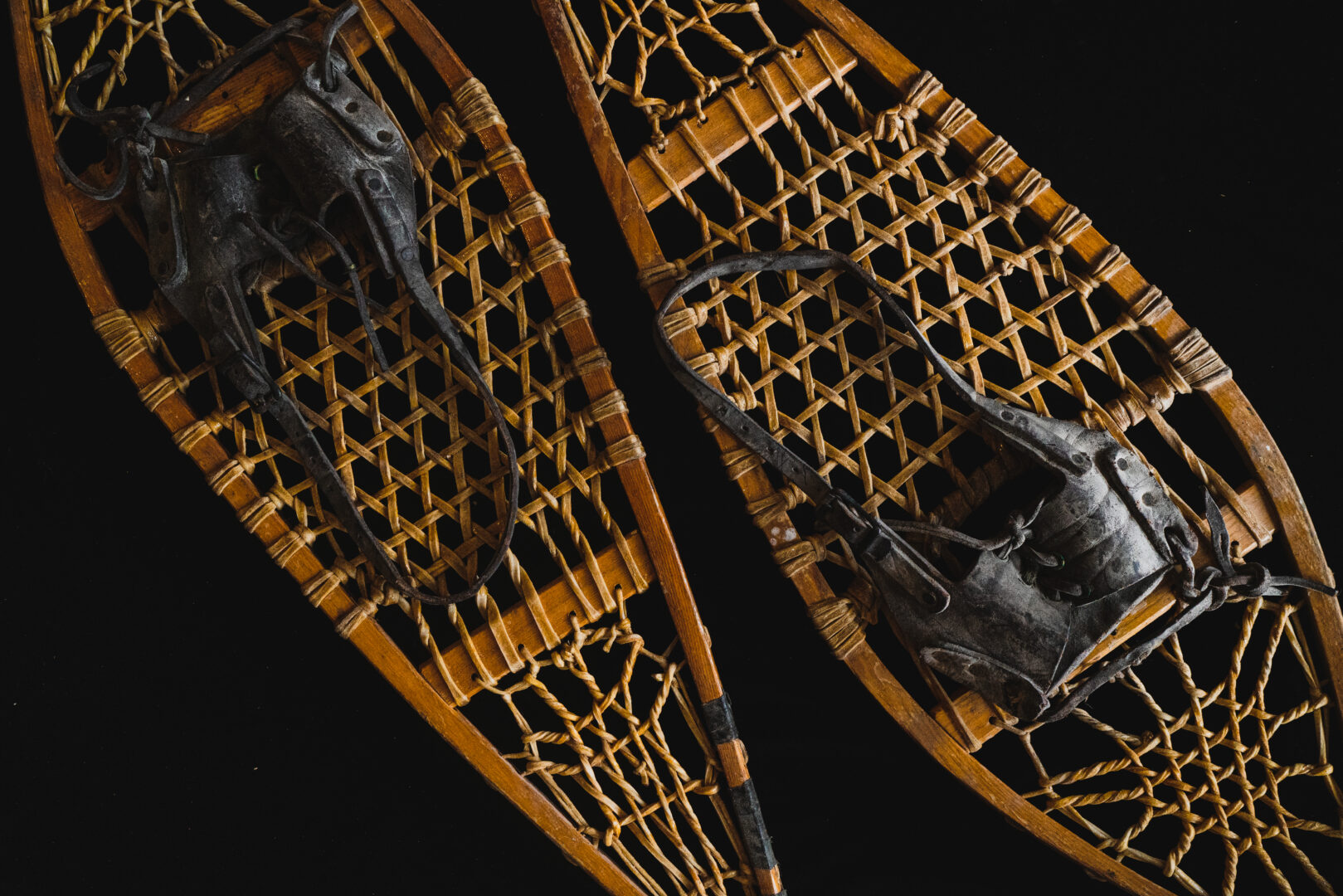 Shot of old fashioned snowshoes on a black background.