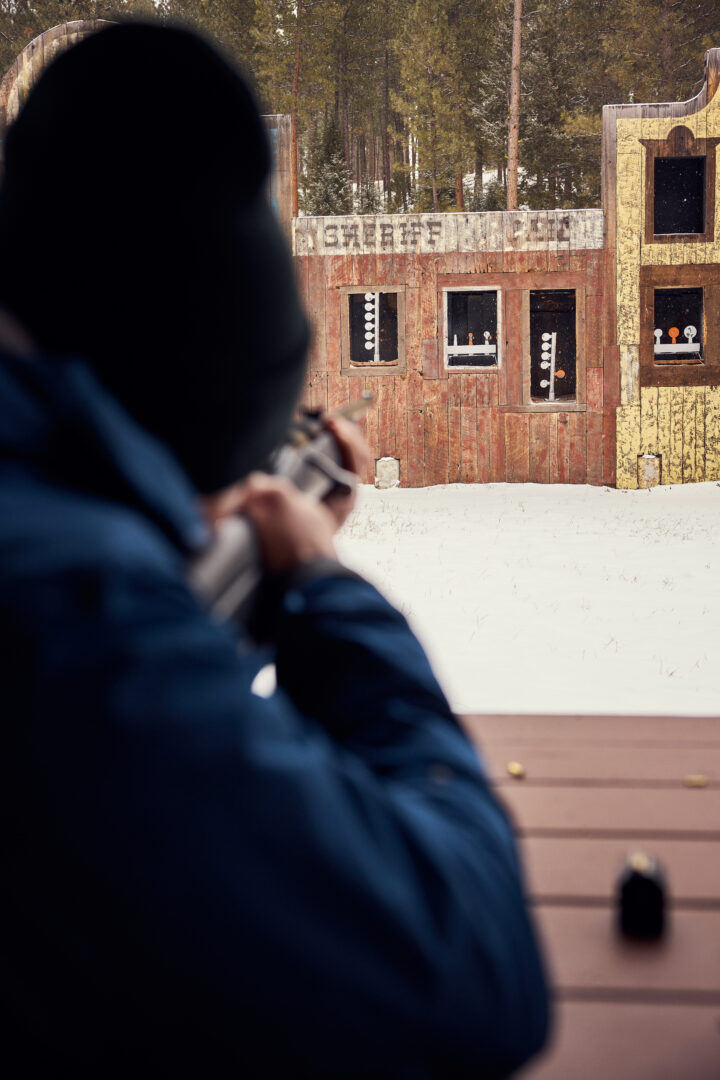Person aiming with .22 rifles from the old west range