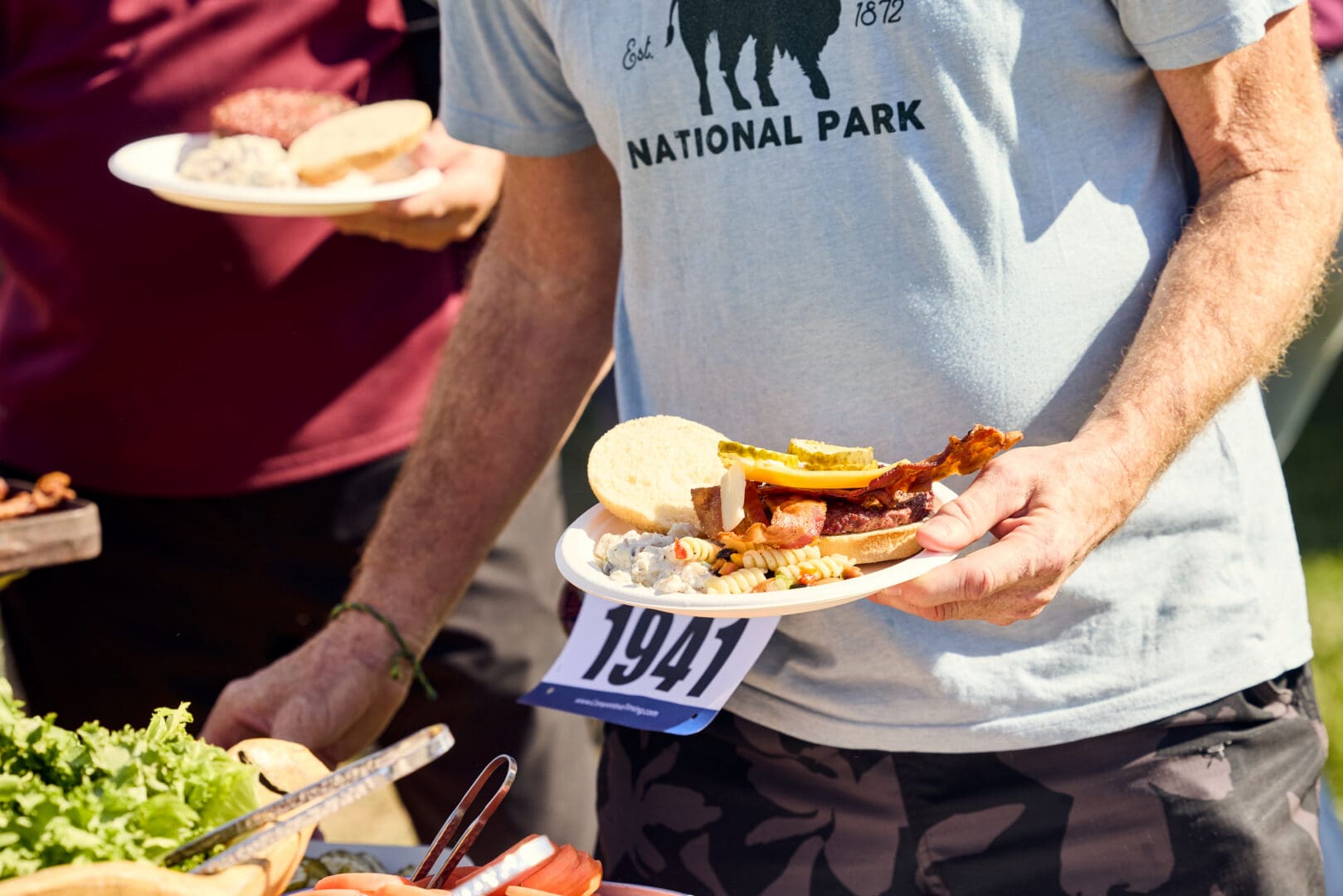 Runner putting buffet food on his plate.