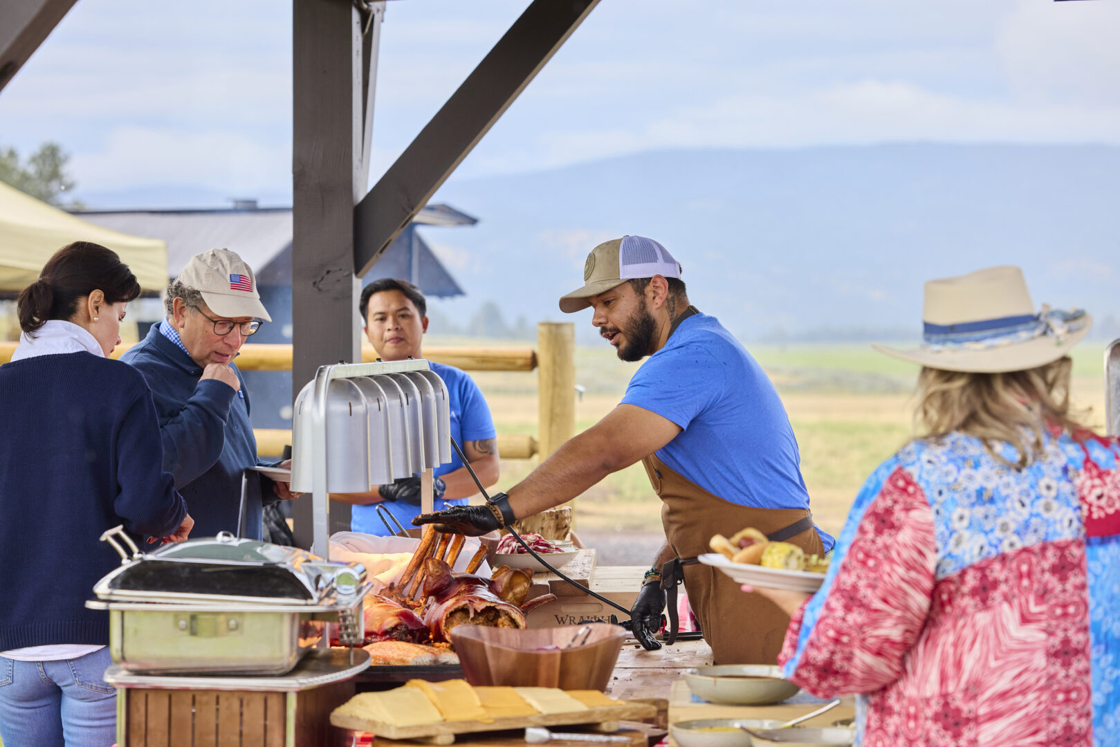 Chef cooking outside at a festival.