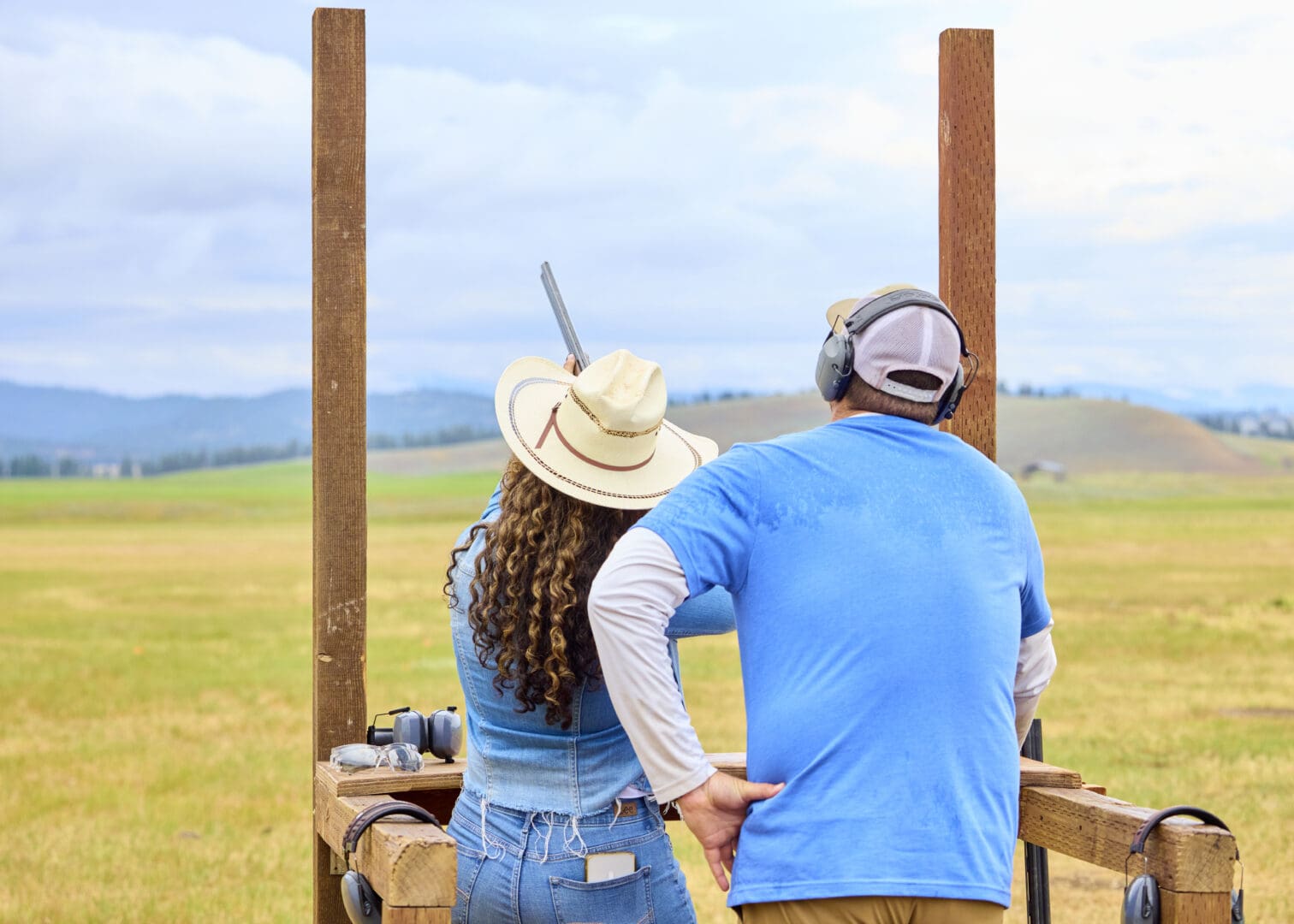 Woman and a man shooting skeet.