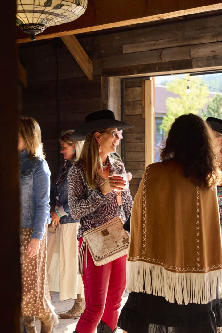 Group of women in western style drinking in an indoor setting.