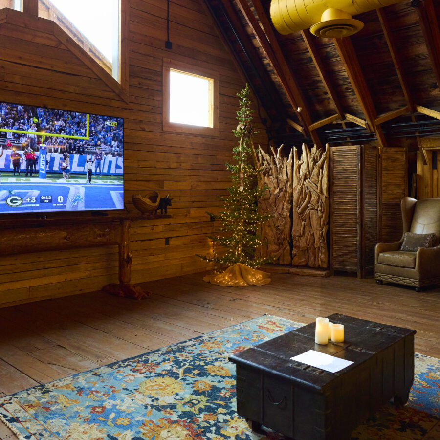 Photo inside a wooden home of a TV with a football on.