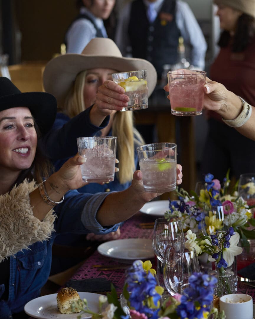 Women toasting their glasses together.