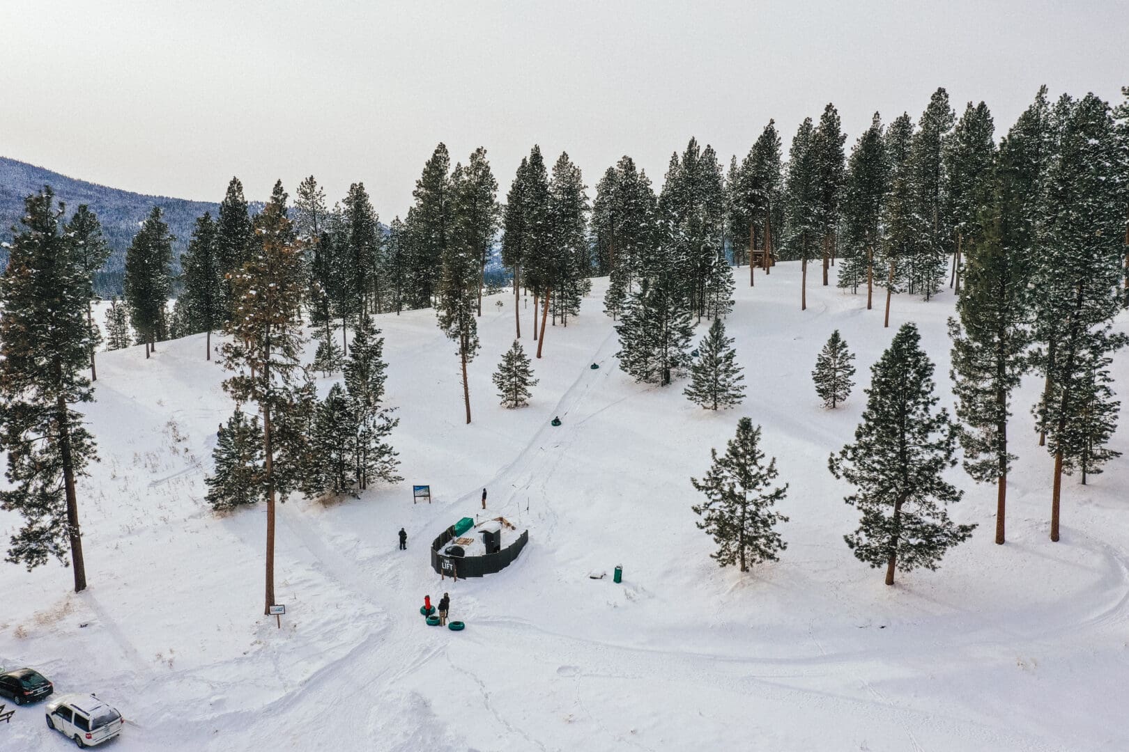 Snow tubing hill surrounded by trees.