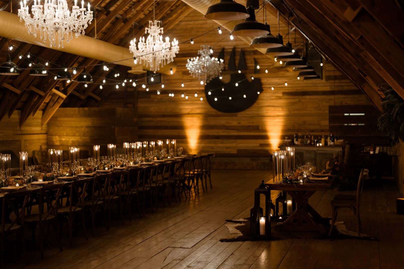 Dark indoor wedding reception in a wooden building.