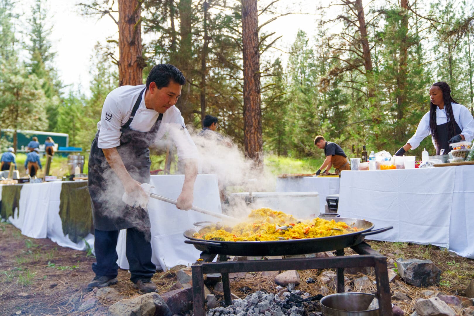 Chef working outside at a wok making a rice dish.