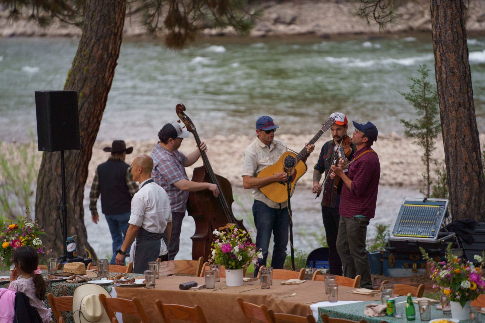 Band warming up for a festival by a river.