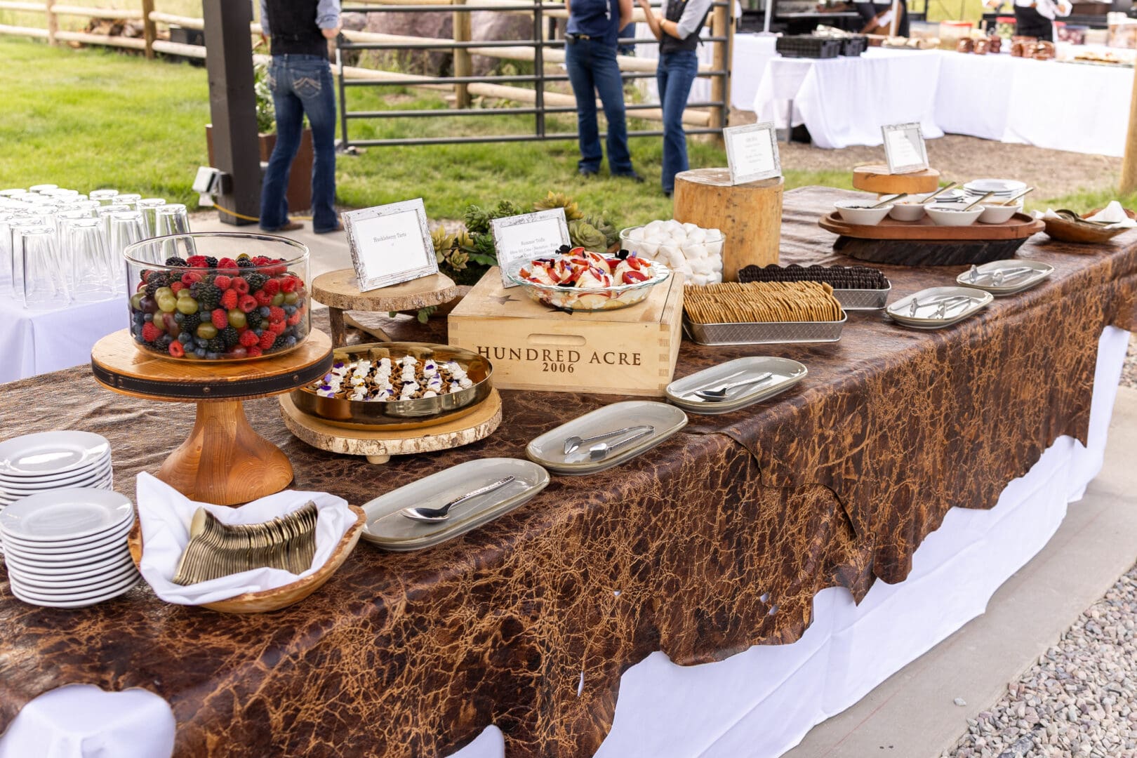 Festive food and desserts lined up on a wooden table.