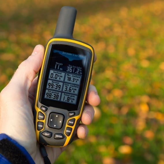 Tracking tool in the hand of a hiker searching for geocaches