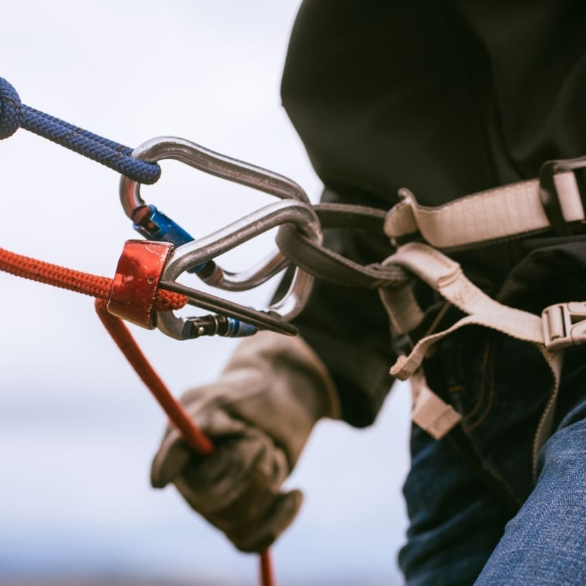 Climbing carabiners being used during a rock climb