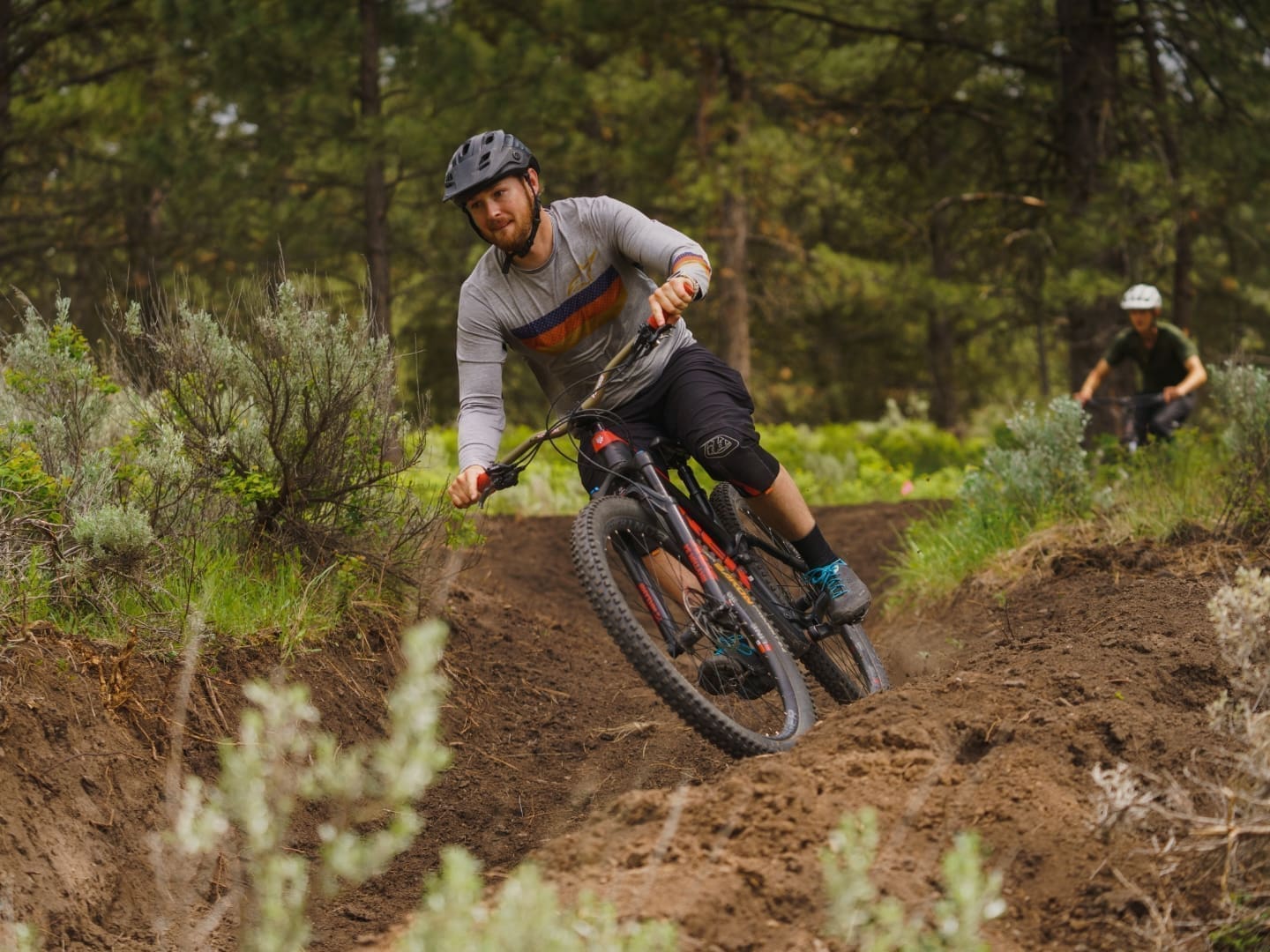 Man riding a mountain bike on a sharp dirt path turn