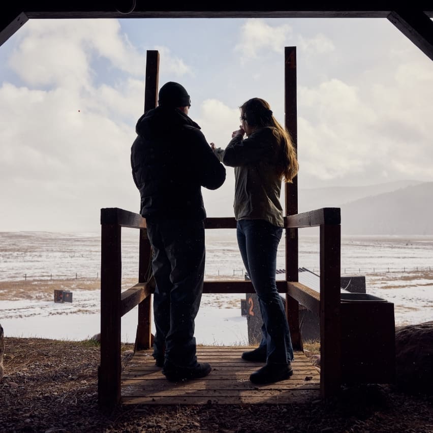 Two people shooting at a winter rifle target from the range