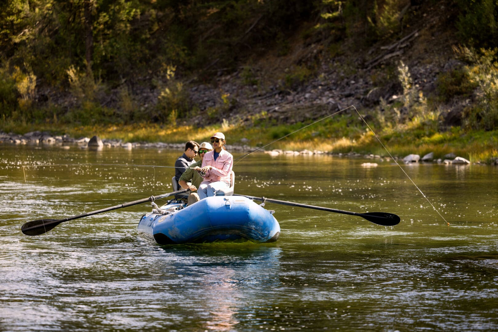Couple fly fishing on a river.