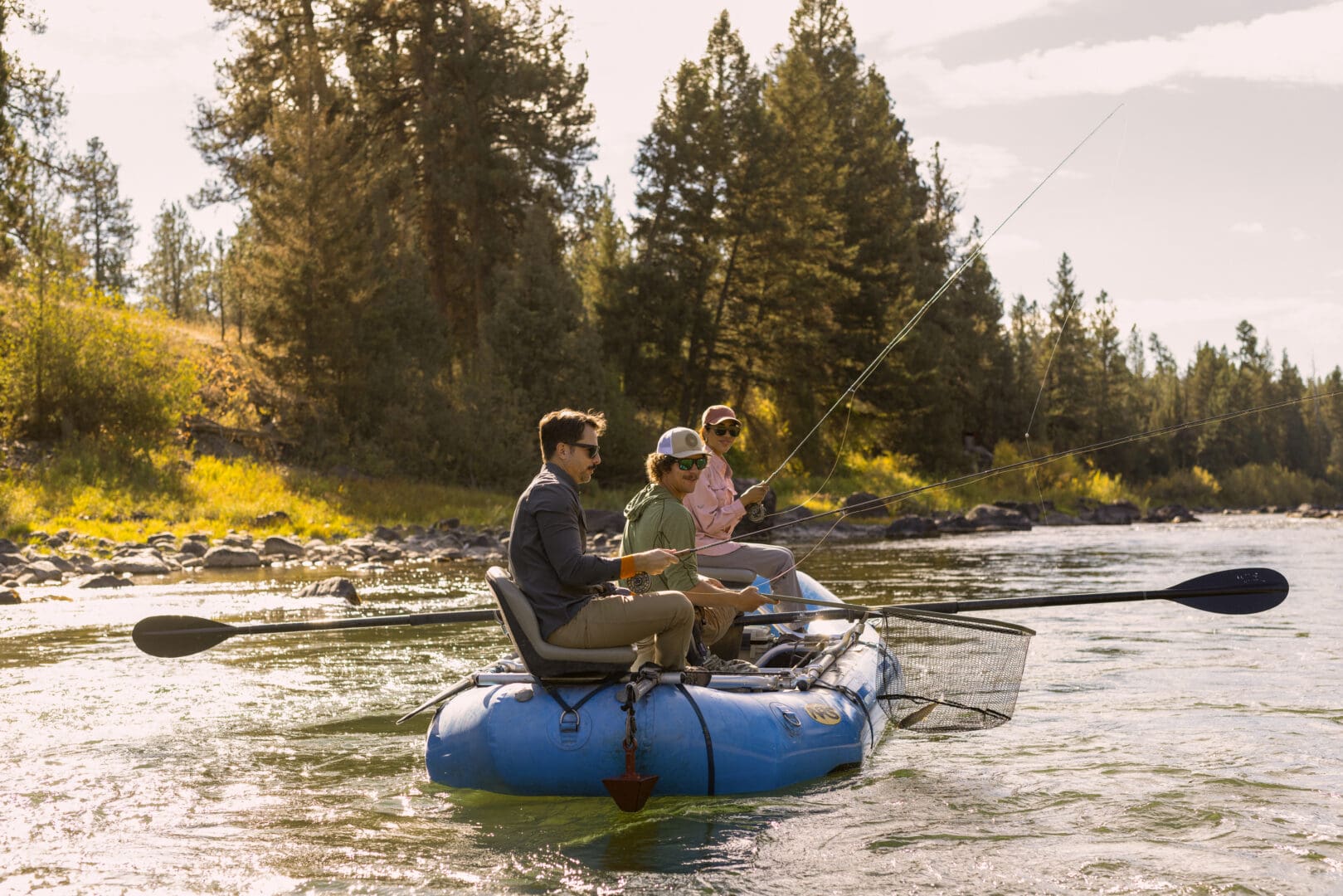 Group of three fly fishing on a river.