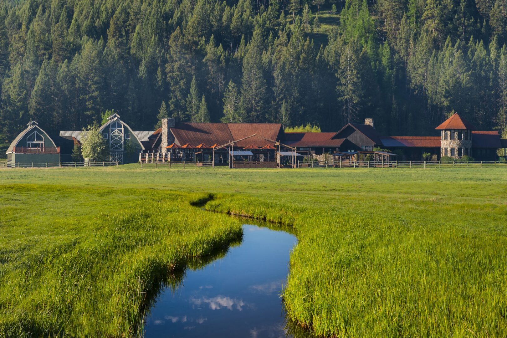 A series of buildings with a stream leading to it.