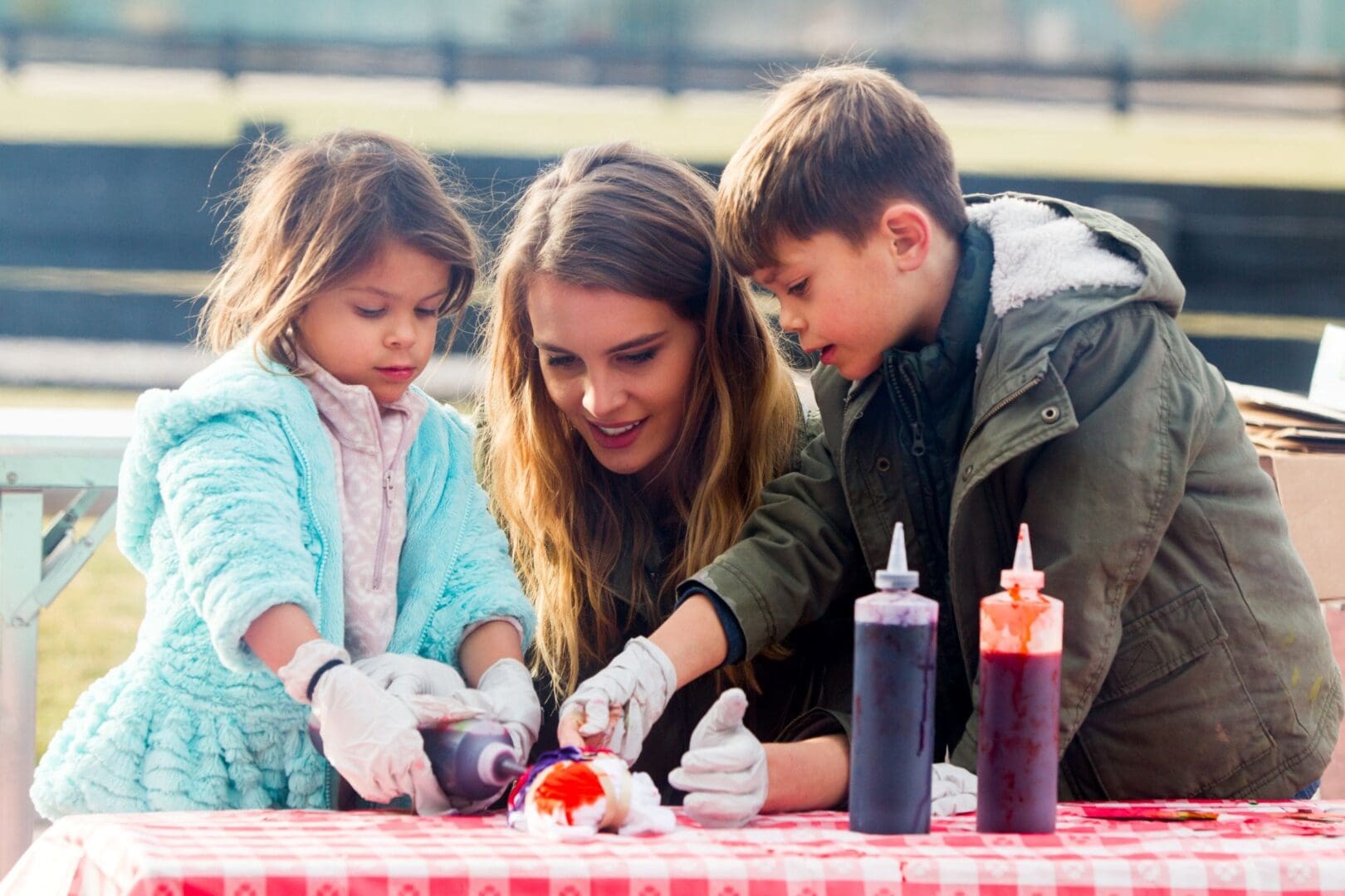 Mom and her kids tie-dying a shirt