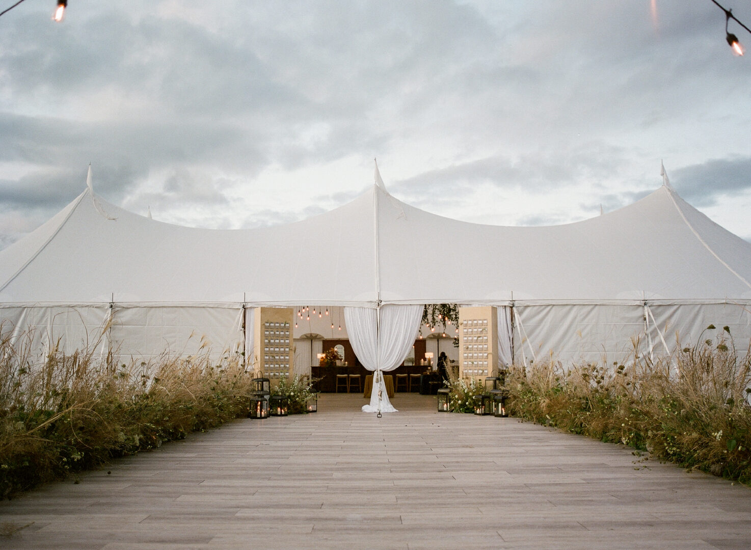 Large white outdoor wedding tent.