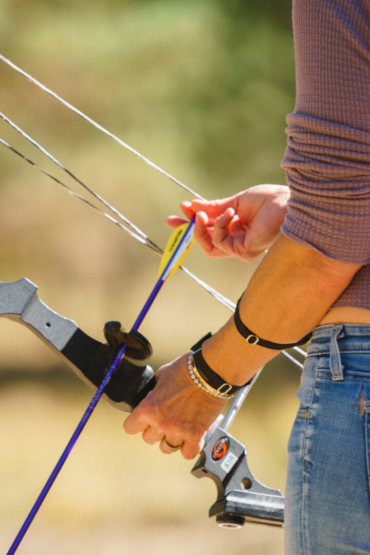 Arm notching a bow and arrow.