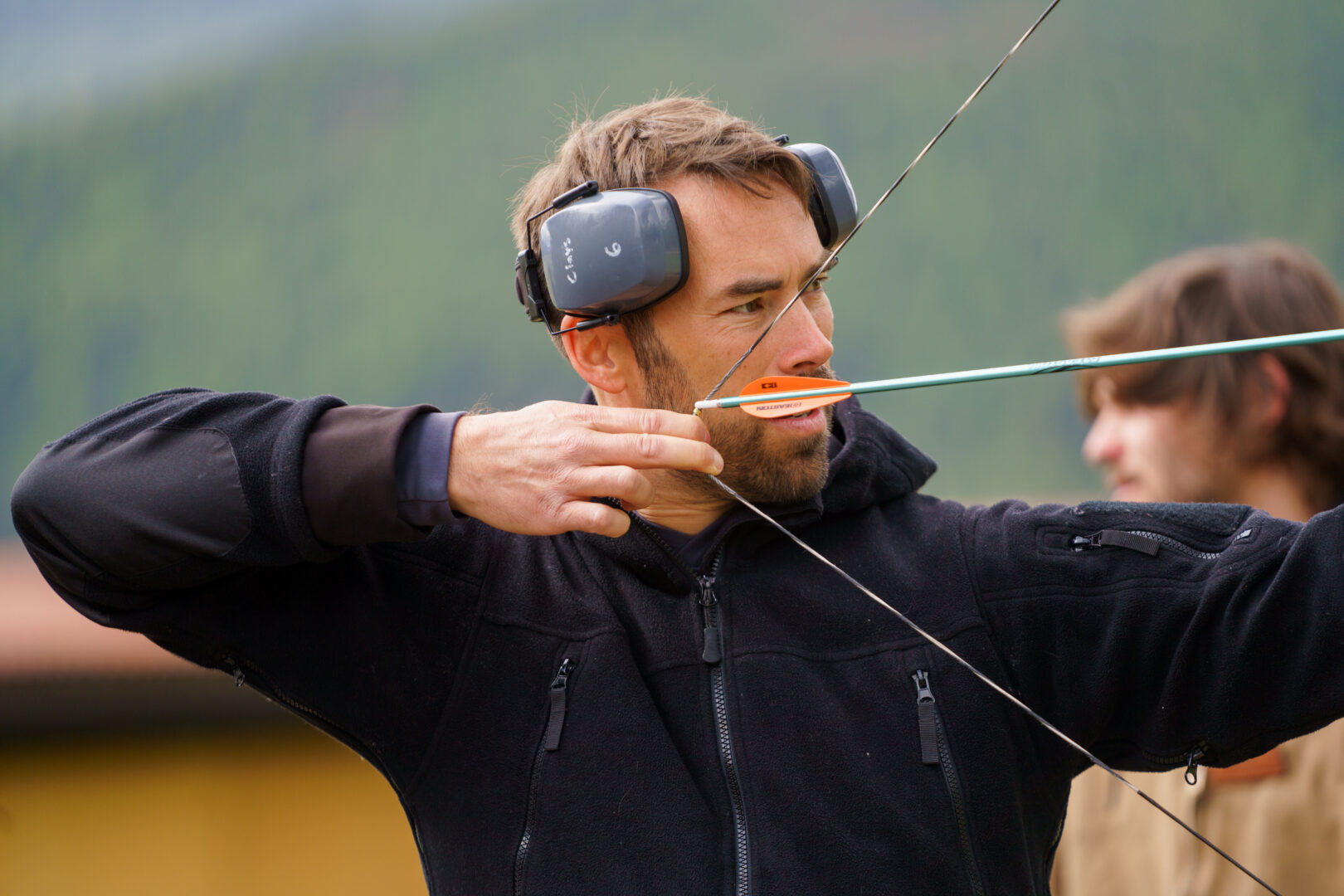 Man shooting a bow and arrow.