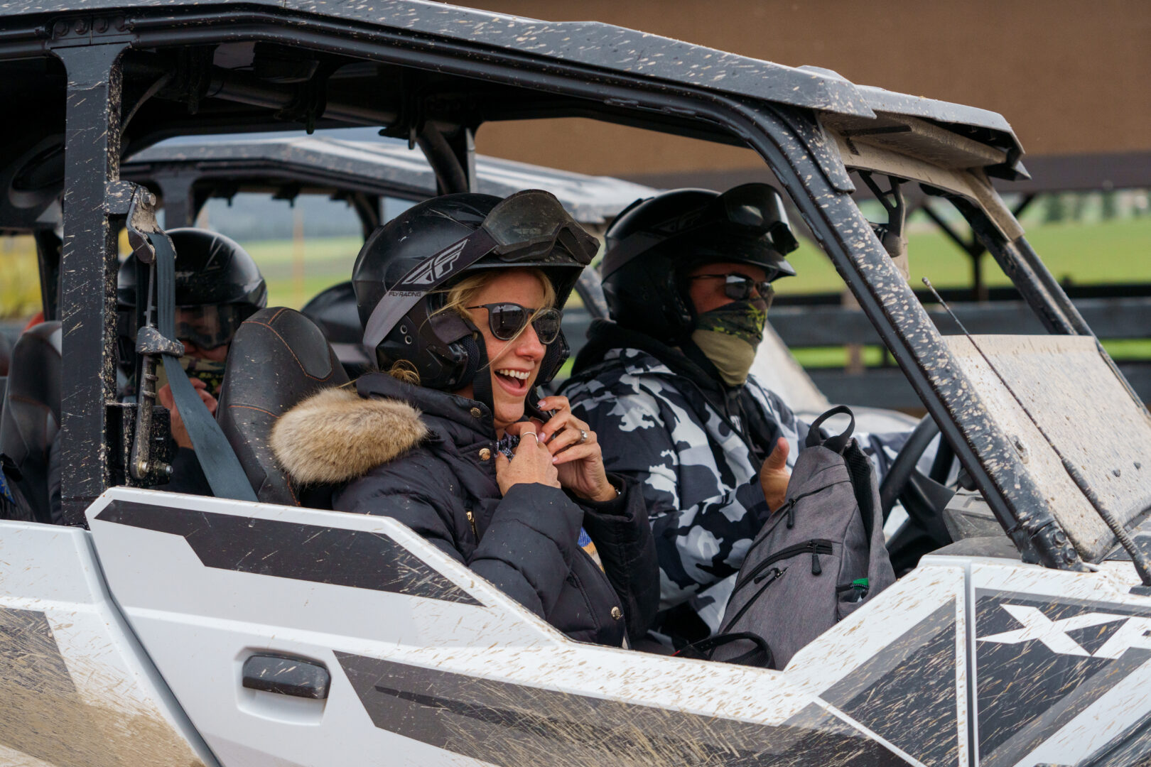 Woman and man riding in a UTV.