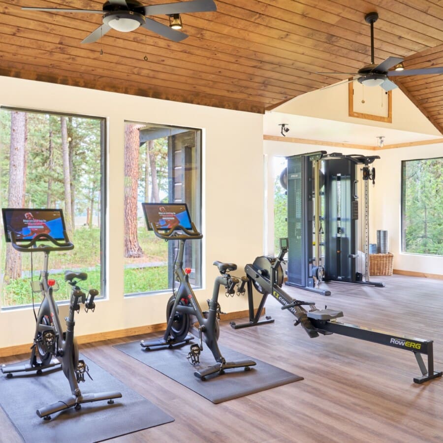 Huff-and-Puff Fitness Center with two stationary bikes, a rowing machine, and a squat rack with beautiful mountain views out of the windows