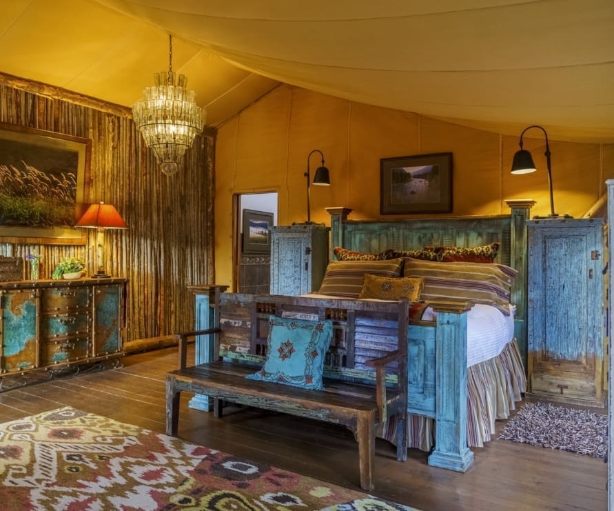 Western-style king bed inside glamping tent