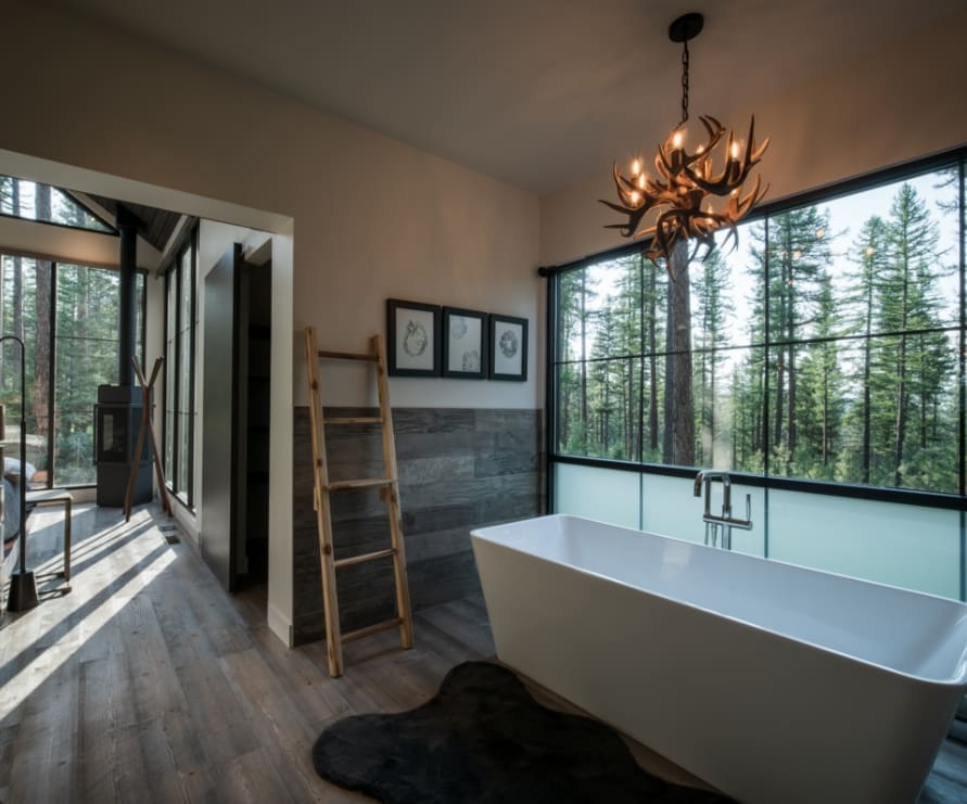 Inside view of the Light Haus bathtub underneath an antler chandelier