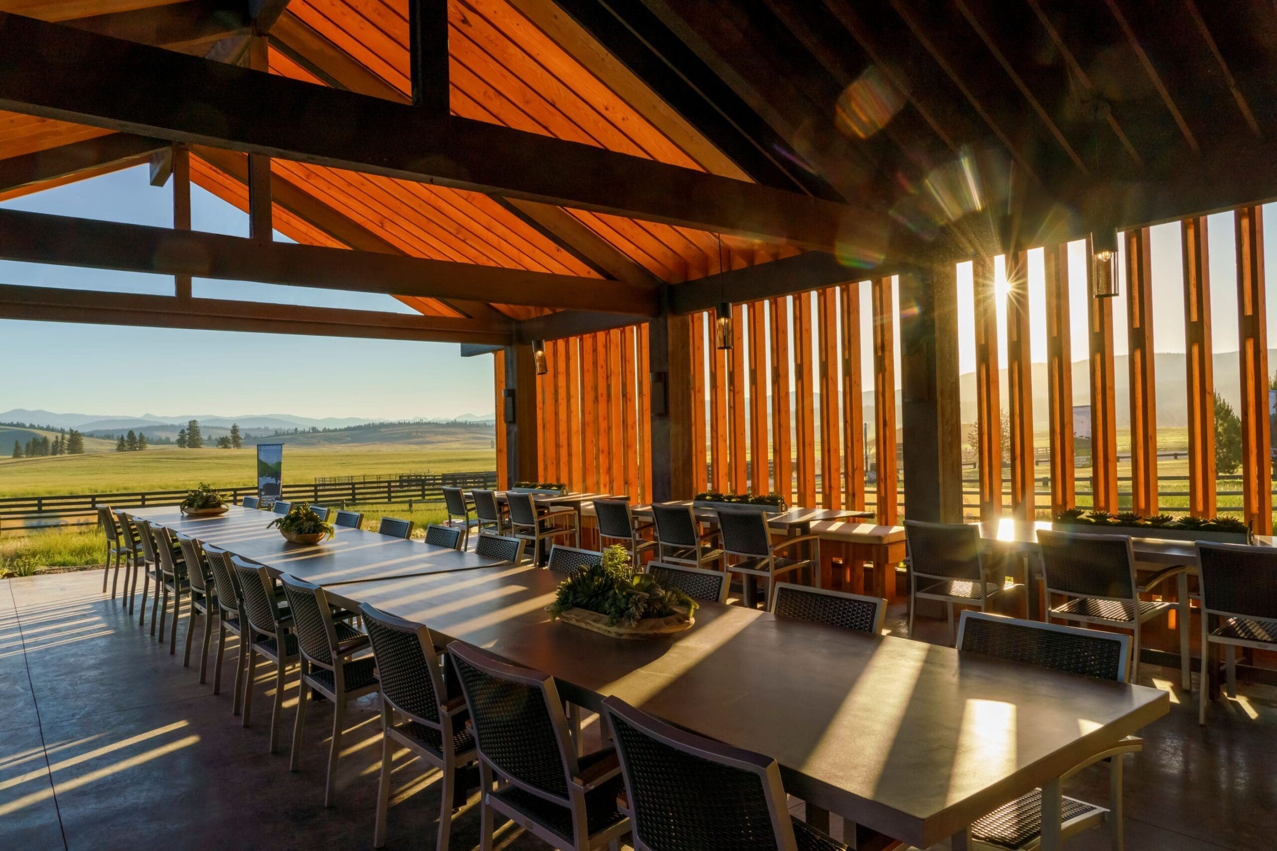 Indoor view of Shed restaurant at Paws Up, an open-air dining pavilion concept with slits in the wooden walls and no doors