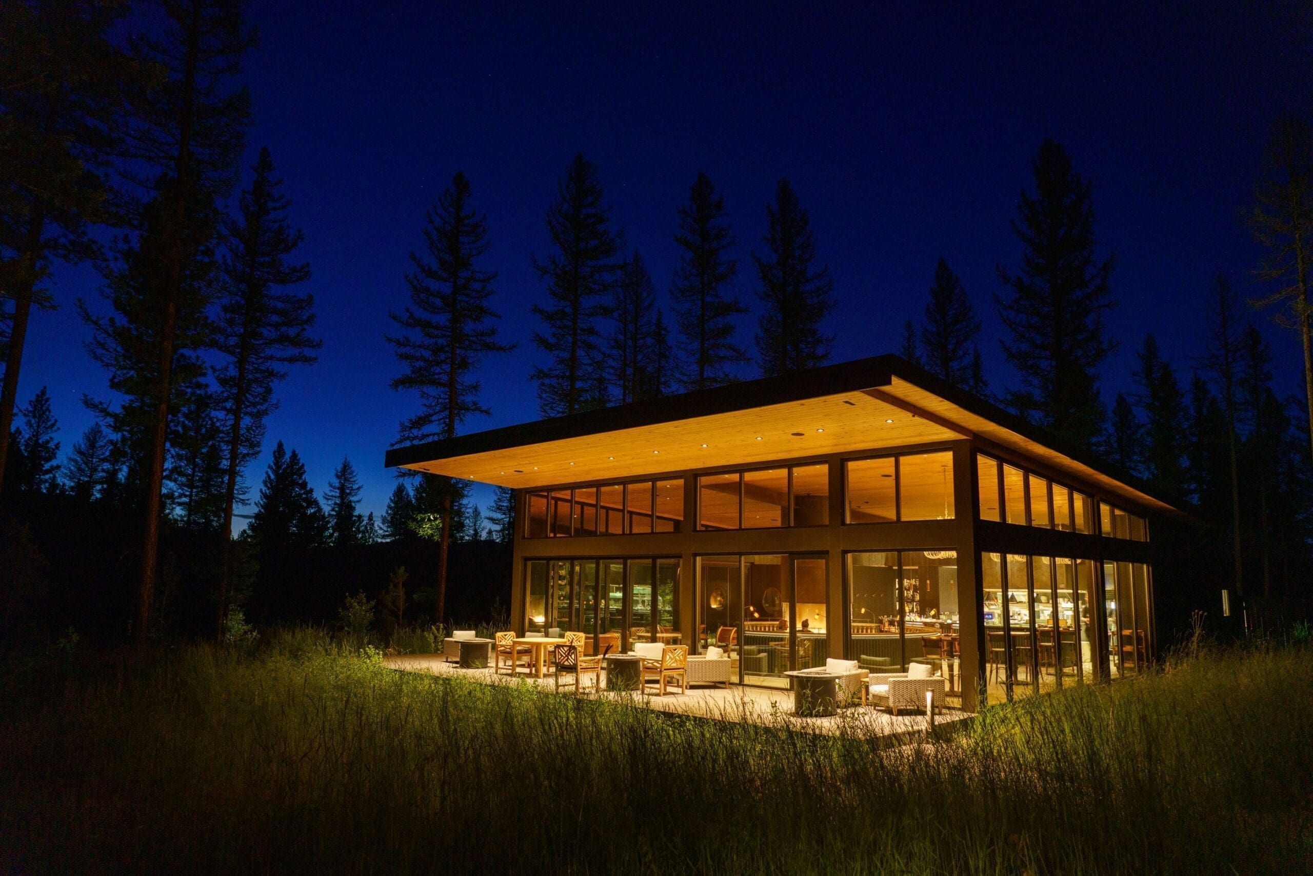 Outside view of Social Haus adults-only restaurant at Green O Paws Up Montana, a modern, luxury restaurant with windows for walls